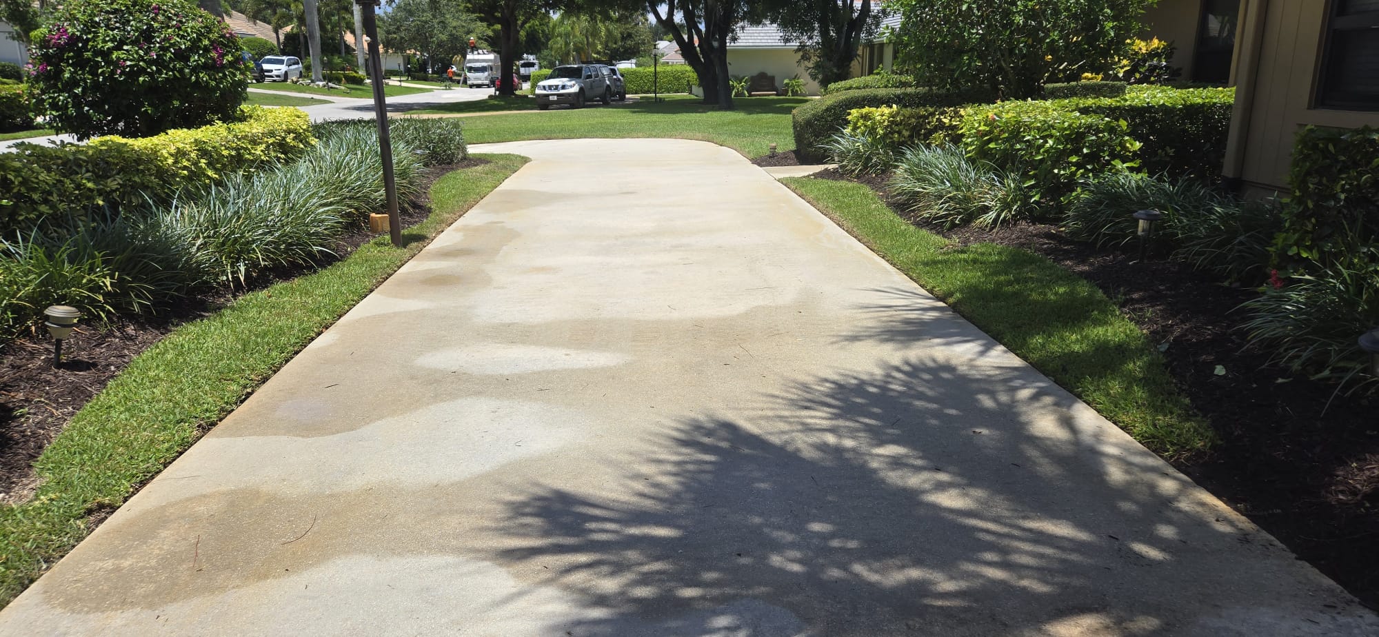 Pressure Cleaning dirt, oil stains, rust stains and tire marks from Concrete Driveway in Pine Tree Country Club Estates in Boynton Beach FL 33436