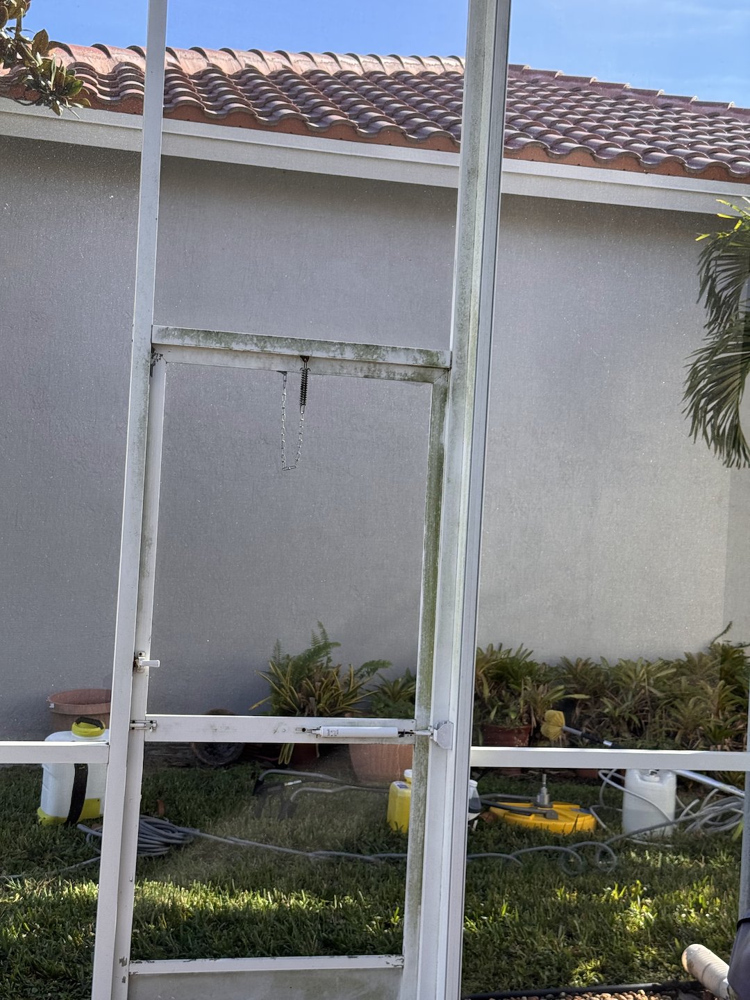 Pressure Washing of home, patio tile floor and lanai in Bellaggio community located in Lantana FL 33467